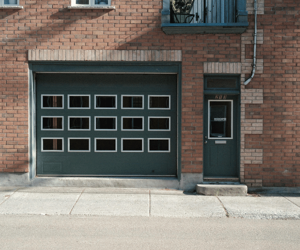 Garage door repair technicians replacing a broken spring in Burlingame