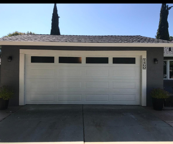 Garage door repair technicians replacing a broken spring in Fremont
