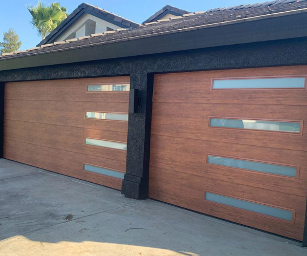 Garage door repair technicians replacing a broken spring in Belmont
