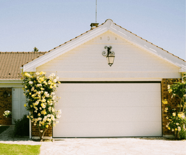 Garage door repair technicians replacing a broken spring in San Bruno