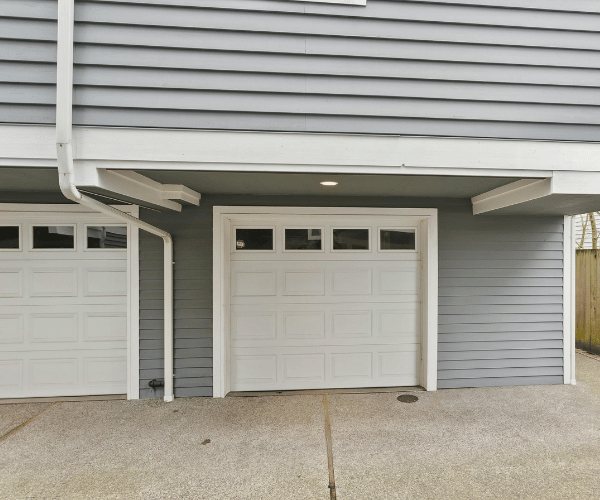 Garage door repair technicians replacing a broken spring in Millbrae