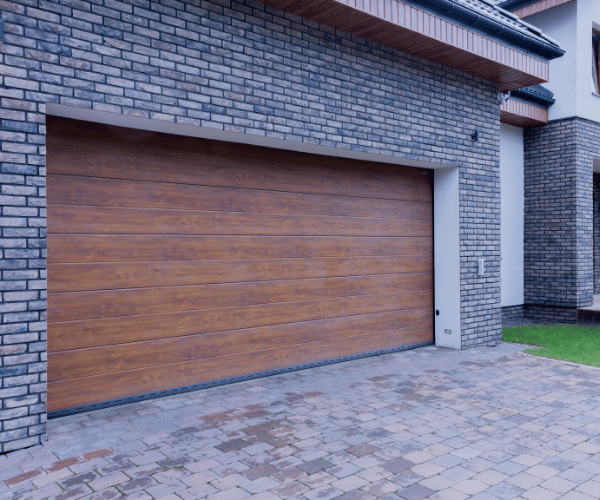 Garage door repair technicians replacing a broken spring in Richmond