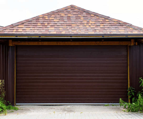 Garage door repair technicians replacing a broken spring in Daly City