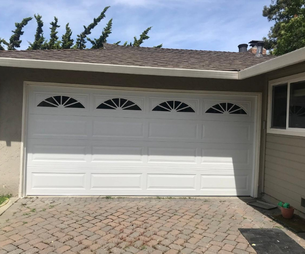 Garage door repair technicians replacing a broken spring in Fremont